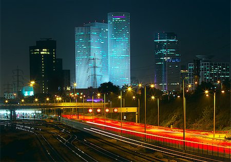 simsearch:614-08877419,k - Night view of Tel Aviv city downtown, illuminated Azrieli towers and light traces on Ayalon highway. Fotografie stock - Microstock e Abbonamento, Codice: 400-06761335