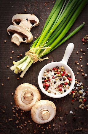 Fresh chives, mushrooms and salt with colorful peppercorns on a dark wooden background. Stock Photo - Budget Royalty-Free & Subscription, Code: 400-06761873