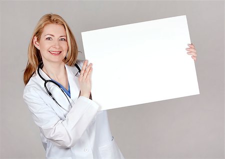 simsearch:400-05745246,k - blond female doctor posing on light grey background Photographie de stock - Aubaine LD & Abonnement, Code: 400-06762070