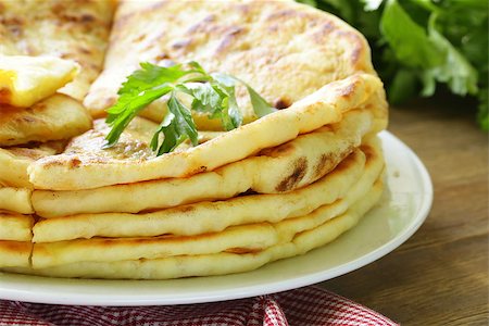 south indian food - pile of fried bread with butter and parsley Stock Photo - Budget Royalty-Free & Subscription, Code: 400-06762162