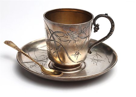 Antiquarian silver cup with a saucer and a  spoon on a white background Photographie de stock - Aubaine LD & Abonnement, Code: 400-06763138