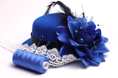 Blue hat with a feather and a flower and a  the White lacy ribbon on a white background Photographie de stock - Aubaine LD & Abonnement, Code: 400-06763139