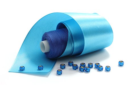 Blue tape, the coil of blue threads and blue  beads on a white background Stock Photo - Budget Royalty-Free & Subscription, Code: 400-06763140