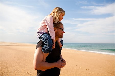 piggyback daughter at beach - Father carrying young daughter piggyback on shoulders at beach Stock Photo - Budget Royalty-Free & Subscription, Code: 400-06763199