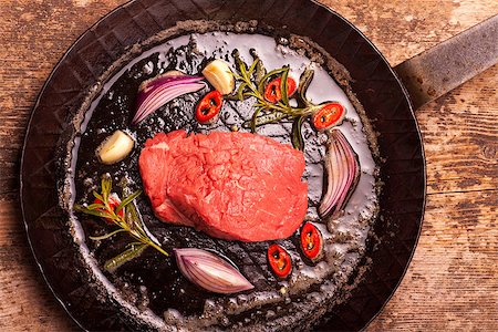 pan fried fillet of beef - raw steak in an iron pan Stock Photo - Budget Royalty-Free & Subscription, Code: 400-06763474