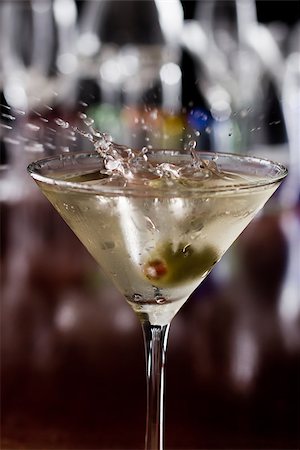 simsearch:400-06797125,k - dirty martini chilled and served on a busy bar top with a shallow depth of field and color lights and glasses in the background Stock Photo - Budget Royalty-Free & Subscription, Code: 400-06763722