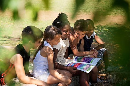 Young people and education, two little girls and boys reading book in city park Stock Photo - Budget Royalty-Free & Subscription, Code: 400-06770222