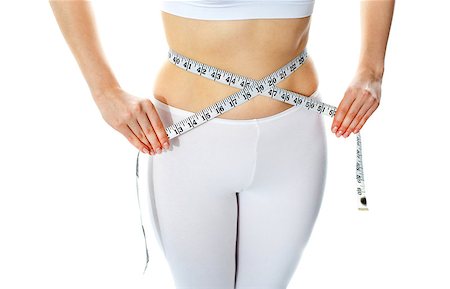 Slim female body shown while measuring waist width with tape metre Stock Photo - Budget Royalty-Free & Subscription, Code: 400-06770809