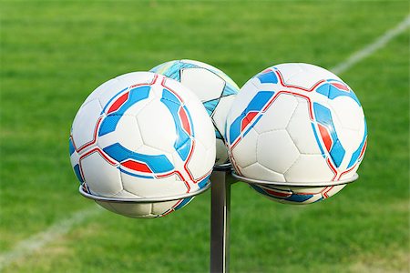 simsearch:400-08372849,k - three football balls on holders with green grass in background Stock Photo - Budget Royalty-Free & Subscription, Code: 400-06771884