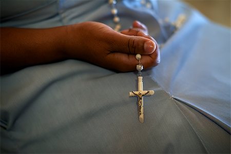 simsearch:400-04968605,k - People and religion, catholic sister praying in church and holding cross in hands. With model release Stock Photo - Budget Royalty-Free & Subscription, Code: 400-06772733