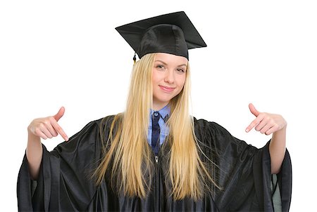 simsearch:400-06772308,k - Happy young woman in graduation gown pointing down on copy space Stockbilder - Microstock & Abonnement, Bildnummer: 400-06772952