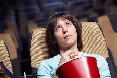 Upset young girl in cinema Stock Photo - Budget Royalty-Free & Subscription, Code: 400-06787494