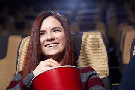 photo of theatre audience laughing - Smiling young girl in cinema Stock Photo - Budget Royalty-Free & Subscription, Code: 400-06787491