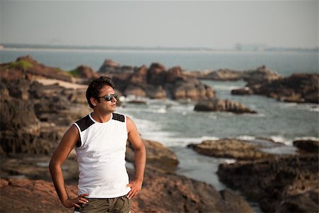 Indian Happy young man getting out of the water with sunglasses Stock Photo - Budget Royalty-Free & Subscription, Code: 400-06787819