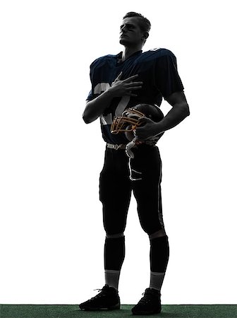 one caucasian american football player man hand on heart in silhouette studio isolated on white background Foto de stock - Super Valor sin royalties y Suscripción, Código: 400-06788147