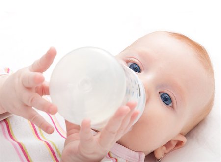 simsearch:400-06073989,k - Baby Girl Drinking Milk from Bottle on White Background - Shallow Depth of Field Photographie de stock - Aubaine LD & Abonnement, Code: 400-06788209