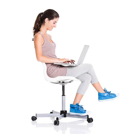 Beautiful student sitting in a chair with a laptop, isolated over a white background Stock Photo - Budget Royalty-Free & Subscription, Code: 400-06788355