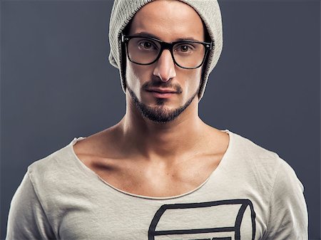 Casual portrait of a young man wearing a cap, over a blue background Stock Photo - Budget Royalty-Free & Subscription, Code: 400-06788397