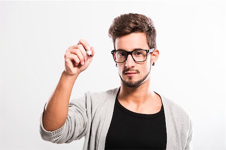 Portrait of a handsome young man wearing glasses and  writting something on a glass writeboard Stock Photo - Budget Royalty-Free & Subscription, Code: 400-06788392