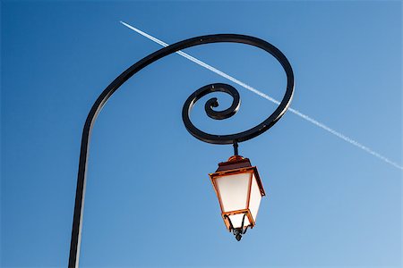 simsearch:400-06945463,k - Shining Backlit Streetlamp and Airplane Trail in Background, Megeve, France Photographie de stock - Aubaine LD & Abonnement, Code: 400-06788813