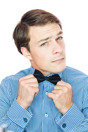 Handsome gentleman with a bow tie isolated on a white background Stock Photo - Budget Royalty-Free & Subscription, Code: 400-06789037