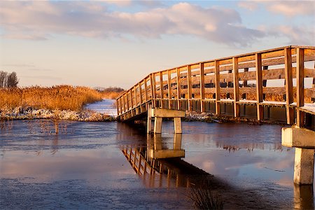 snow road horizon - wooden bridge over river during sunrise Stock Photo - Budget Royalty-Free & Subscription, Code: 400-06789536