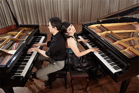 Two people, a couple playing duet musical performance with two grand pianos Photographie de stock - Aubaine LD & Abonnement, Code: 400-06789575