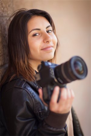 Attractive Mixed Race Young Adult Female Photographer Against Wall Holding Camera. Stock Photo - Budget Royalty-Free & Subscription, Code: 400-06789708