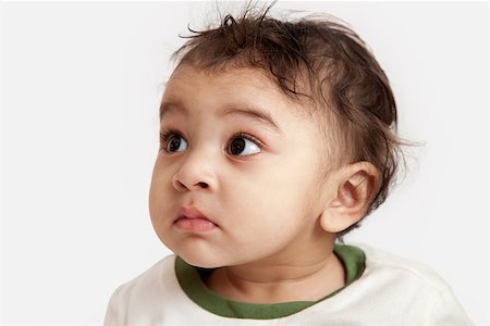 Curious indian kid looking at the camera on white background. Stock Photo - Budget Royalty-Free & Subscription, Code: 400-06789912