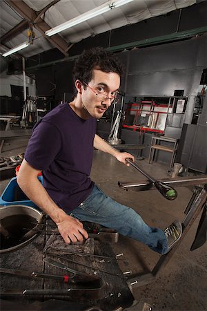 Serious young adult with tools and workbench in glass factory Stock Photo - Budget Royalty-Free & Subscription, Code: 400-06794023