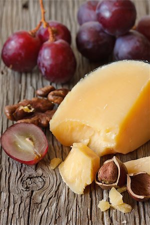 Delicious cheese, grape and nuts on an old wooden board. Stock Photo - Budget Royalty-Free & Subscription, Code: 400-06794396