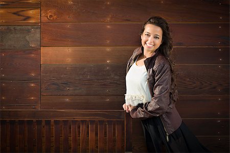 Portrait of a Pretty Mixed Race Young Adult Woman Against a Lustrous Wooden Wall Background. Stock Photo - Budget Royalty-Free & Subscription, Code: 400-06794533