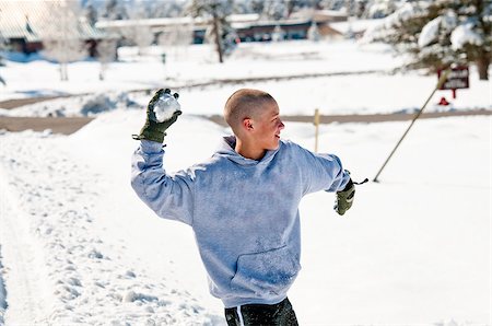 Happy bald boy wearing a hood throwing a snowball. Stock Photo - Budget Royalty-Free & Subscription, Code: 400-06794632