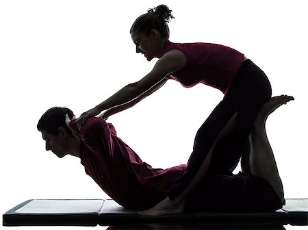 full body massage - one man and woman performing thai massage in silhouette studio on white background Foto de stock - Super Valor sin royalties y Suscripción, Código: 400-06794901