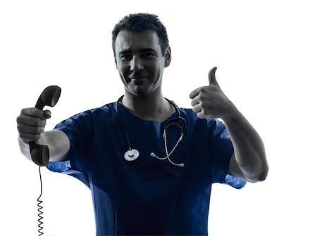 one caucasian man doctor surgeon medical worker  holding phone thumb up gesture silhouette isolated on white background Stock Photo - Budget Royalty-Free & Subscription, Code: 400-06795043