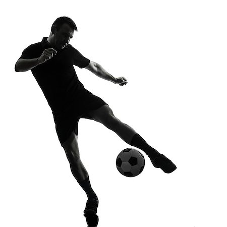 football man kicking white background - one man soccer player in studio silhouette isolated on white background Stock Photo - Budget Royalty-Free & Subscription, Code: 400-06795058