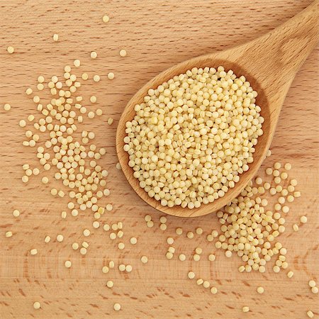 staple - Pearl couscous in wooden spoon over beech wood background. Photographie de stock - Aubaine LD & Abonnement, Code: 400-06795276