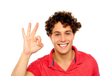 simsearch:400-06795514,k - Curly hair guy gesturing excellence sign. Isolated on white Photographie de stock - Aubaine LD & Abonnement, Code: 400-06795523