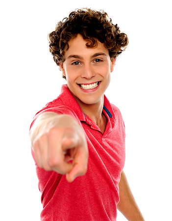 simsearch:400-06795514,k - Handsome curly hair teen pointing at you. Dressed in casuals Photographie de stock - Aubaine LD & Abonnement, Code: 400-06795532