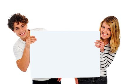 simsearch:400-06695536,k - Attractive smiling couple holding a blank whiteboard. Isolated Stock Photo - Budget Royalty-Free & Subscription, Code: 400-06795561