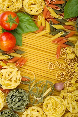 simsearch:400-06796271,k - Overhead various Italian pasta background with tomatoes, basil and garlic Stock Photo - Budget Royalty-Free & Subscription, Code: 400-06796066