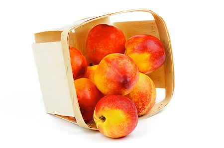 simsearch:400-04709478,k - Heap of Perfect Ripe Nectarines Scattered of Basket closeup isolated on white background Foto de stock - Super Valor sin royalties y Suscripción, Código: 400-06796647