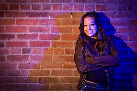 Portrait of a Pretty Mixed Race Young Adult Woman Against a Brick Wall Background. Stock Photo - Budget Royalty-Free & Subscription, Code: 400-06797824