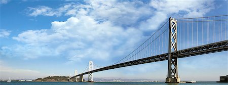 simsearch:400-07514840,k - San Franciscoâ??Oakland Bay Bridge with White Puffy Clouds on Blue Sky Panorama Stock Photo - Budget Royalty-Free & Subscription, Code: 400-06798067