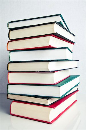 simsearch:400-05145983,k - Stack of red, green and black books on white reflective surface Stock Photo - Budget Royalty-Free & Subscription, Code: 400-06798624