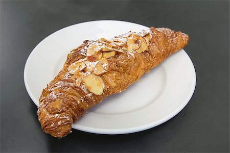 Almond Croissant French Pastry on White Plate Stock Photo - Budget Royalty-Free & Subscription, Code: 400-06798666