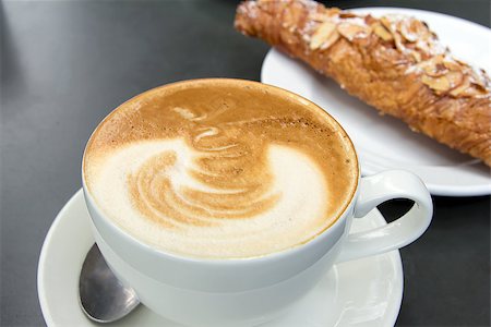 Cup of Caffe Latte with Almond Croissant in Background Stock Photo - Budget Royalty-Free & Subscription, Code: 400-06798667