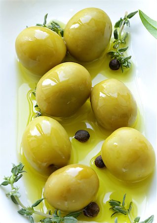 eating olive - green olives with fragrant oil and spices Stock Photo - Budget Royalty-Free & Subscription, Code: 400-06798675