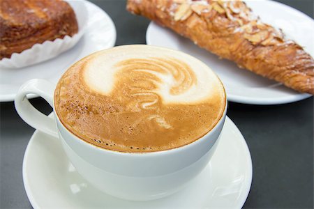 Cup of Caffe Latte with Almond Croissant Pastry in Background Stock Photo - Budget Royalty-Free & Subscription, Code: 400-06798924