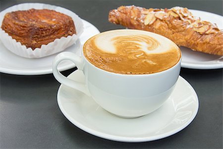 Cup of Caffe Latte with Almond Croissant and Flaky Pastry in Background Stock Photo - Budget Royalty-Free & Subscription, Code: 400-06798925